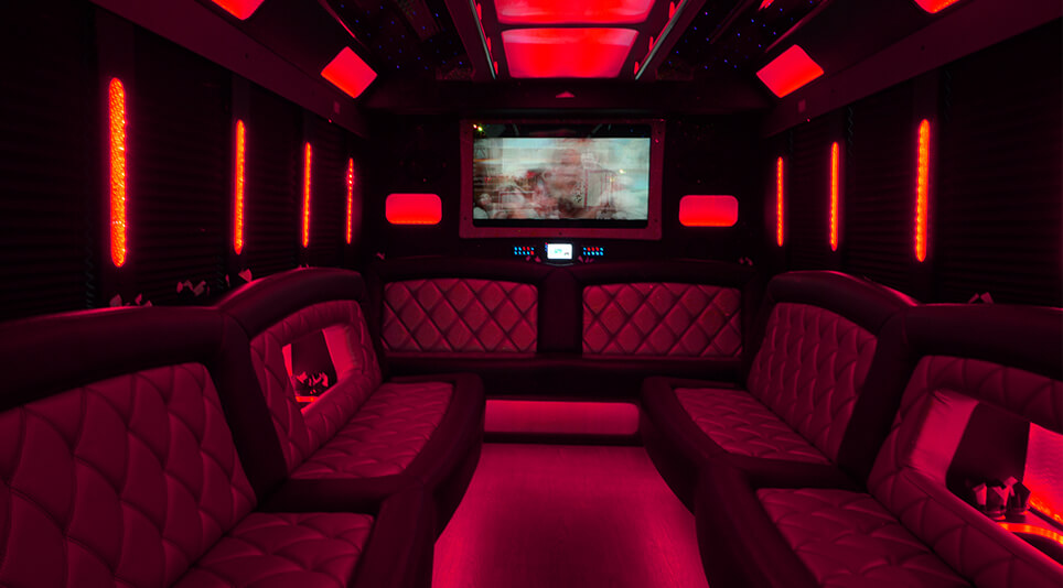 wide TV screens inside a party bus