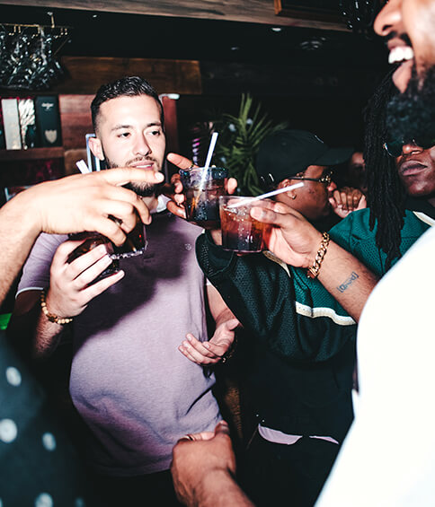 boys sharing drinks at a bar