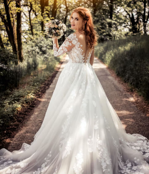 lovely bride showing her wedding dress